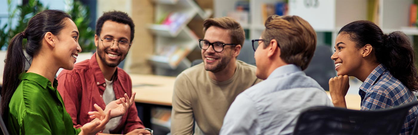 group of smiling people having a conversation